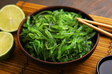 Tasty seaweed salad in bowl served on table, closeup