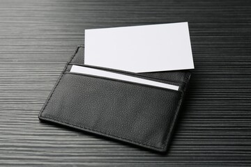 Leather business card holder with blank cards on grey table