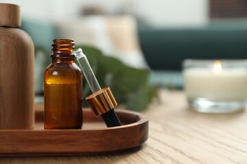 Aromatherapy. Bottles of essential oil on wooden table, space for text
