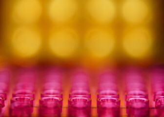 Colorful abstract background with repeating pattern of defocused circles in golden yellow and pink...