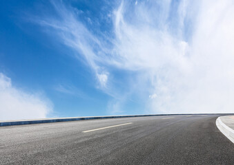 Road stretching into the clear blue sky.