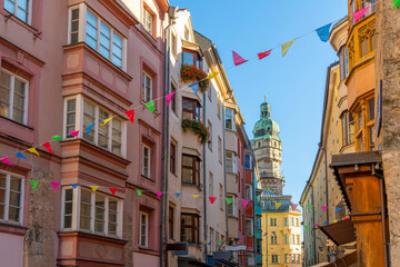 The Stadtturm medieval city clock and watchtower rises above the colorful medieval alleys and...