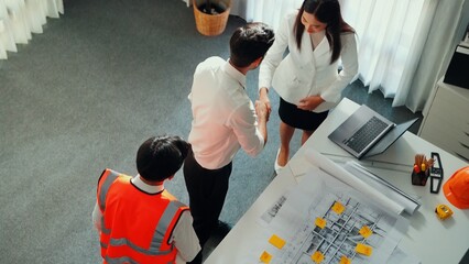 Top view of project manager and civil engineer holding laptop while explain idea to architect....