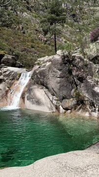 PAN SLOW The Po&ccedil;o Azul (Blue Well) is an idyllic lagoon with crystal-clear water that comes from the Landeira stream, which flows through granitic rocks to create a waterfall in the Peneda-Ger&ecirc;s Park.