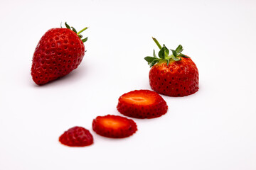 some sliced strawberries on a white background with red color