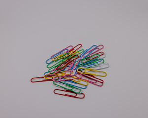 Closeup of a paper clips on a grey background.