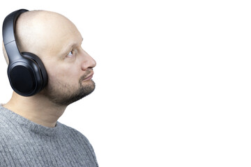 Fototapeta premium This is a captivating portrait of a man, set against a stark white background. He is clad in a finely knit grey wool sweater, his gaze directed upwards, embodying a sense of optimism and contentment