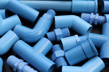 Plumber equipment with blue pvc pipe connections for plumbing work.