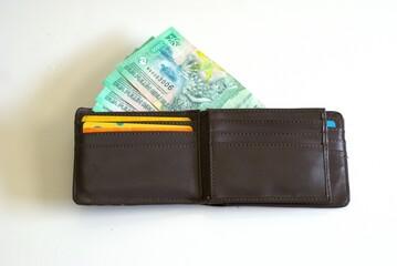 Leather wallet with bank card and Indonesian rupiah banknotes, Twenty thousand rupiah in wallet...