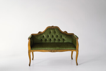 An exquisite antique sofa upholstered in plush green velvet stands gracefully. The tufted backrest...