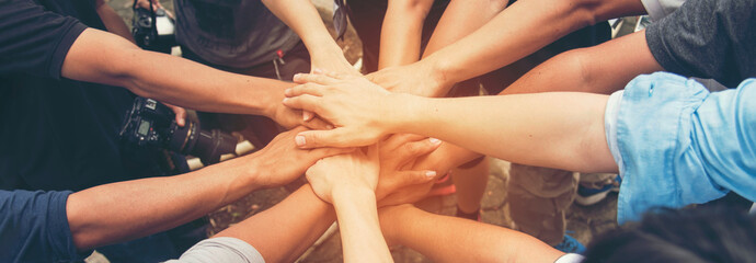 Banner diversity solidarity team multiethnic Partners hands together teamwork. Group of multiracial...