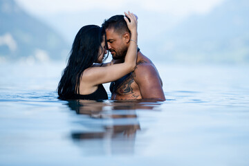 Sexy vacation. Sex on the beach. Erotic sensual couple kissing in the water. Summer sexy couples....