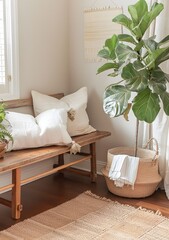small plant sits in the corner of an open plan room, next to a wooden bench with white pillows and some baskets on it