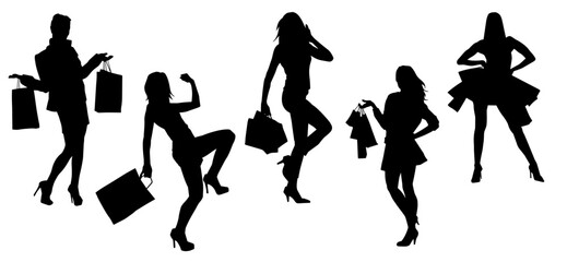 Silhouette of  slim young woman carrying shopping bags.