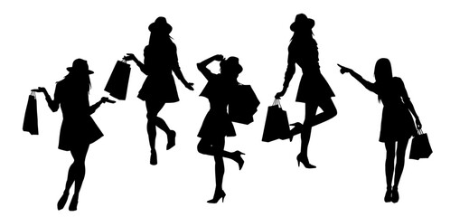 Silhouette of  slim young woman carrying shopping bags.