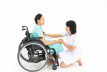 Nurse caring for a patient in a wheelchair on white background