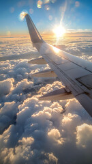 A plane wing is seen in the sky with clouds and the sun shining on it