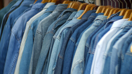 Denim jackets lined up in a clothing store