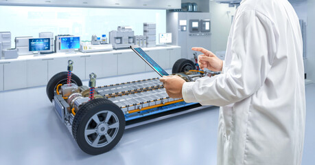 Asian engineer or technician work with ev car battery cells module in laboratory