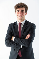 A young businessman in a suit stands with a smile and arms crossed, isolated on a white background.