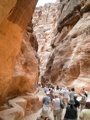 A large number of the tourists walk along the Al Siq gorge of the Petra historical reserve in the...