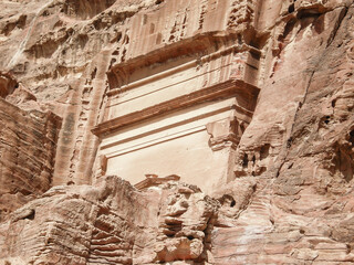 The remains  of facade of one of Nabatean tombs in historical center of Petra in Wadi Musa city in...