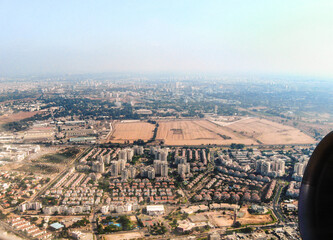Fototapeta premium View from the window of an airplane taking off from Ben Gurion Airport and flying over Tel Aviv city in Israel towards the Mediterranean Sea and Europe