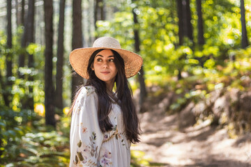 Beautiful young woman walking in the forest