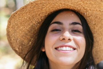 Portrait of a happy woman with a straw hat