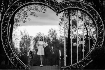 Portrait of a young beautiful blonde girl outdoors. Black and white photo.
