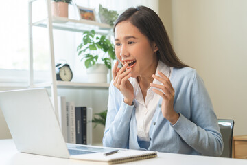 Excited with computer, happy celebrating success asian young woman, girl amazed looking good news...