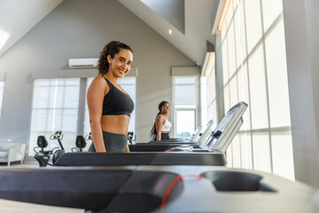 woman sportwear exercise running treadmill fitness in gym health club. sportswoman slim motivation...