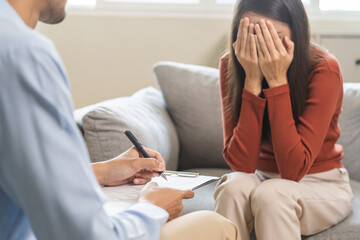 Psychology, depression. Sad asian young woman consultation with psychologist while patient...