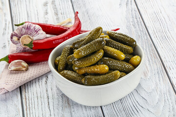 Marinated small cucumbers in the bowl