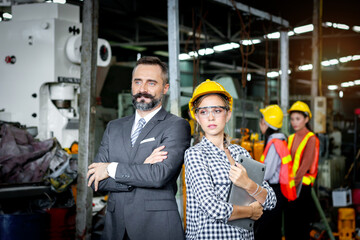 Portrait of senior businessman manager with beautiful woman industrial engineer worker with helmet...