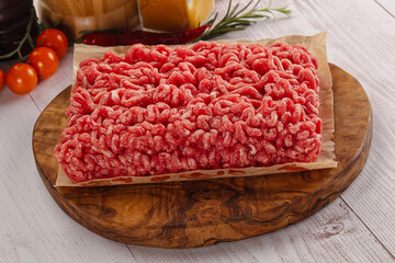 Raw minced beef meat over board