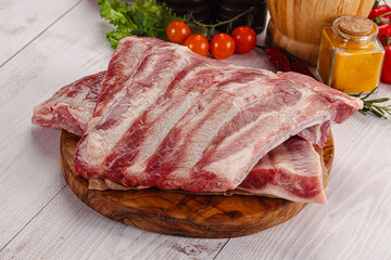 Raw pork ribs over board