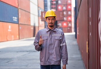 Thump up Portrait Asia logistic engineer man worker or foreman working at container site	