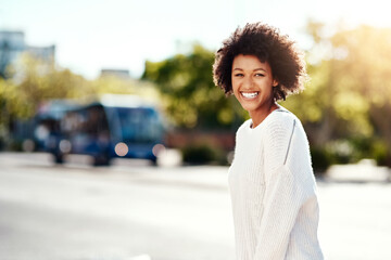 Portrait, girl and smile in crossing street, outdoor and afro in urban, fashion and natural hair....