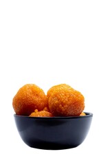 Motichoor Laddu or Motichur Laddoo in a Black Bowl Isolated on White Background with Copy Space, Also Known as Bundi Ladoo