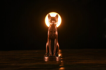 Ancient Egypt goddess Bast (Bastet) silluethe in the lights close up.