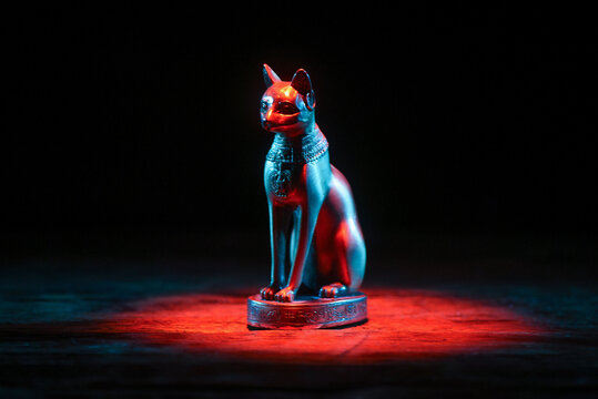 Ancient Egypt goddess Bast (Bastet) silluethe in the lights close up.