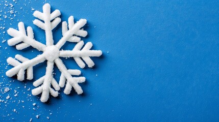   A solitary snowflake against a blue backdrop, beneath it, a layer of snowflakes forms the base