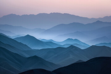 Fototapeta premium The elongated shadows of mountain ridges cast by the soft light of sunset