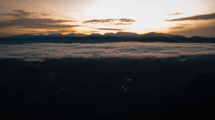 Golden sunrise above the Titiwangsa range mountains surrounded by the sea of clouds in Lenggong, Perak.