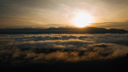 Sea clouds during golden sunrise above the Titiwangsa range mountains in Lenggong, Perak.