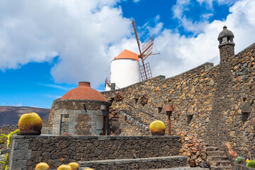 Picture of the windmill with walls and footpath in the cactus garden Jardin de Cactus of Lanzarote