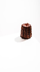 Caneles de bordeaux - traditional French sweet dessert with white table background.