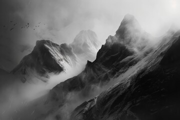 The image is a black and white photo of a mountain range with a foggy atmosphere