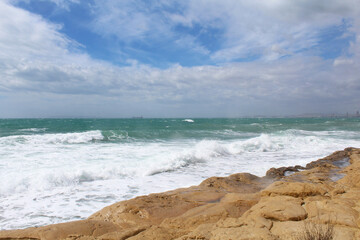 Fototapeta na wymiar beach and sea,natural background texture sky, sea and stone, Mediterranean coast in Spain, waves on the sea, 